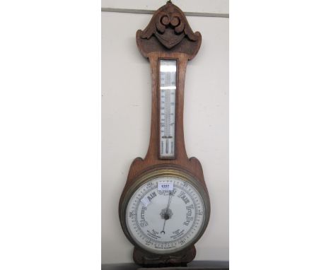 Early 20th Century oak cased aneroid barometer thermometer, 79cms high together with 1950's Bakelite aneroid barometer (at fa