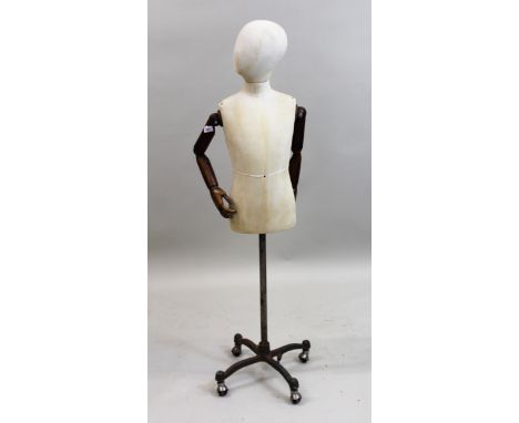 20th Century antique style dressmaker's dummy with articulated wooden arms on metal standThis is a child's mannequin 