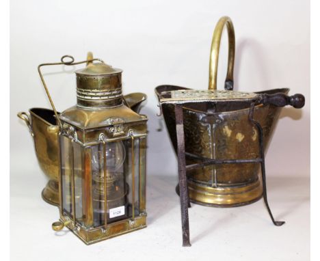 Ship's brass mast head lamp, 46cms high, together with a brass trivit and two brass helmet shaped coal scuttles 