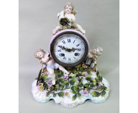 19th Century Sitzendorf floral encrusted and cherub mounted porcelain mantel clock, the enamel dial with Roman and Arabic num