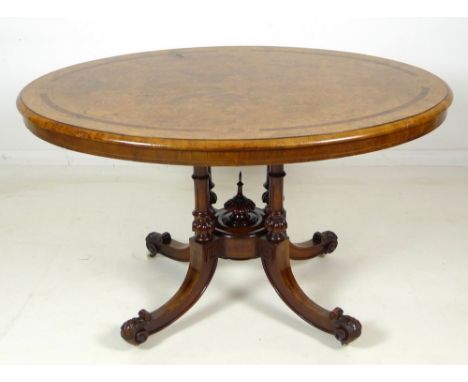 A Victorian walnut loo table, the oval tilt top, quarter burr walnut veneered surface with line inlay, set with four Tunbridg