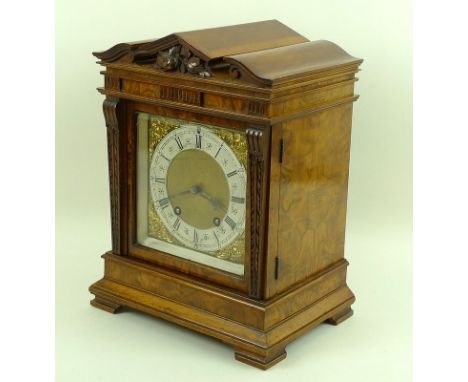 A Victorian burr walnut mantel clock by Lenzkirch,1 Million, with a 15cm silvered chapter ring, winged masked spandrels, the 