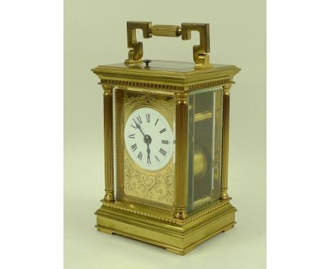 A brass minute repeater carriage clock, by Charles Frodsham, London, with white enamel dial set within a foliate engraved gil