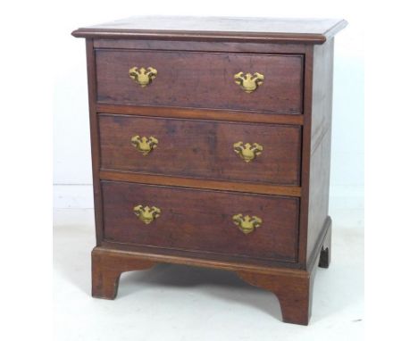 A late Georgian mahogany chest of three drawers, of small proportions, the graduating drawers with cock beading and brass pla