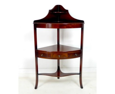 A Edwardian mahogany corner washstand, shaped gallery with quarter shelf, lower tier with single drawer and two false fronts,