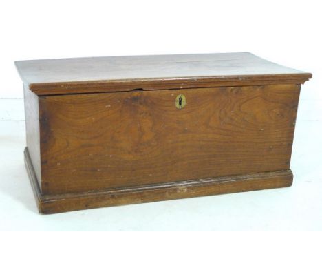 A small 19th century oak blanket box, with lift lid, candle box and brass escutcheon, carved to the front 'E R 1818', mouldin