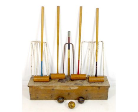 A vintage Lillywhite lawn croquet set, No. 18 stencilled to the box, with four mallets, six white painted metal hoops, centra