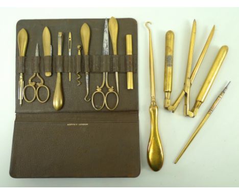 An Asprey of London ladies ten piece necessaire kit, in a brown leather carrying case, a set of curling tongs, a crochet hook