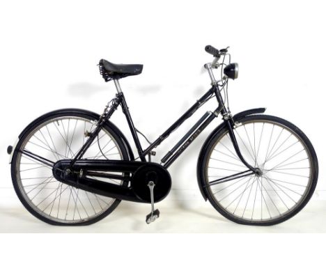 A vintage Raleigh Sports lady's bicycle, circa 1950, painted black with white lettering, styled mud guards, front and rear li