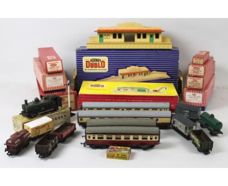 A group of Hornby Dublo OO gauge, comprising an 0-6-0 Tank Engine, D1 Through Station, Goods Depot, a Suburban Coach 4027, tw