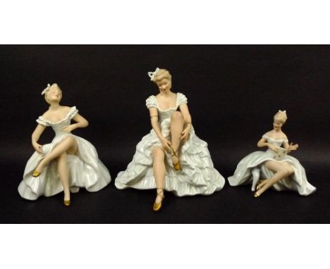 A group of three Wallendorf porcelain figures, comprising a seated ballerina tying her shoe ribbon, number 1316/1, 23cm, a se