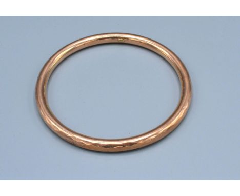 A 9ct Gold Bangle 14.2 grams 9cm diameter 