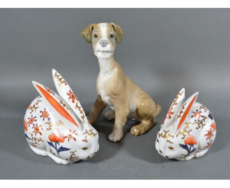 A Lladro Porcelain Model if the form of a dog together with two Japanese Imari models of rabbits 