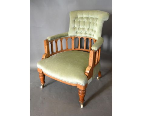 A Late Victorian Walnut and Marquetry inlaid Drawing Room Armchair, the buttoned upholstered back upon shaped uprights and a 