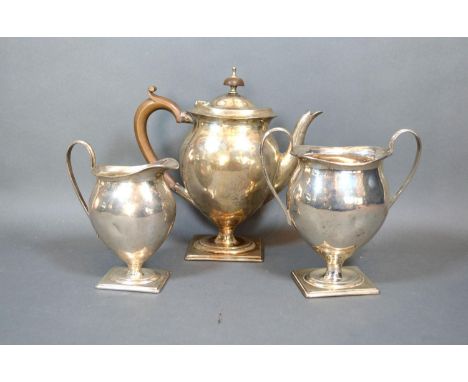 A George V Silver Three-Piece Tea Service Comprising Teapot, Sucrier and Cream Jug all of oviform with rectangular pedestal b