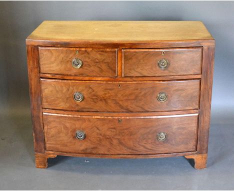 A 19th Century Mahogany Bow Fronted Chest with two short and two long drawers circular brass handles raised upon bracket feet