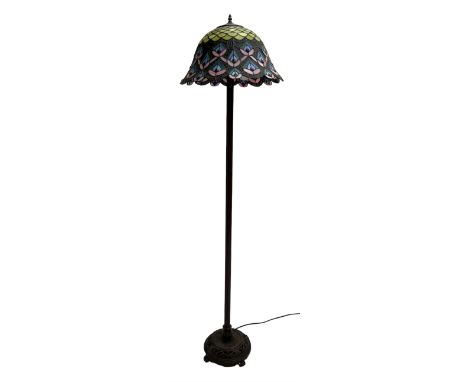 Tiffany style standard lamp, peacock feather lead and coloured glass shade, reeded stem on circular base cast with flower hea