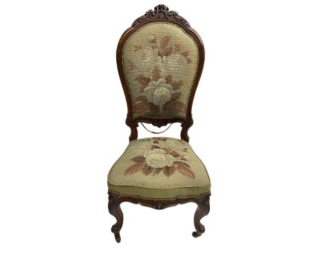 Victorian simulated rosewood framed nursing chair, the cresting rail carved with scrolls and foliage, upholstered in floral n