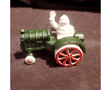 Cast iron Michelin Man on a Tractor figure, L: 12 cm. UK P&amp;P Group 1 (£16+VAT for the first lot and £2+VAT for subsequent