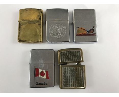 A brass Zippo lighter together with four others
