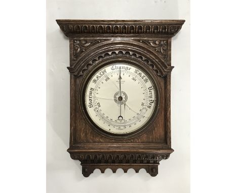 A late 19th / early 20th Century Maple &amp; Co aneroid barometer in carved oak case, 43 cm, (glass cracked)