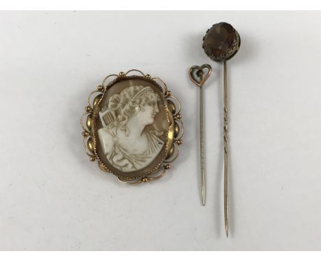 A late 19th / early 20th Century cameo brooch in a yellow-metal mount, stamped 9ct (a/f), together with a yellow-metal stick 