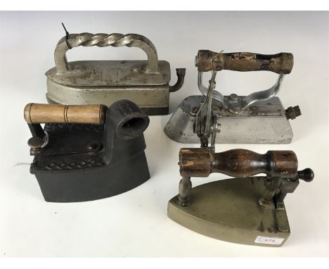 A vintage charcoal iron together with three others