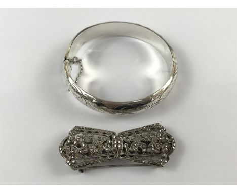 An early 20th century white-metal convertible double dress-clip brooch, together with a white-metal hinged bangle, the latter