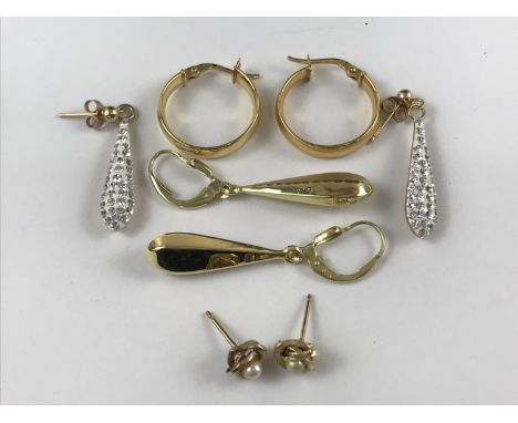 Contemporary yellow-metal earrings, including a pair of ear pendants faced with white-enamel and rhinestones, a pair of facet