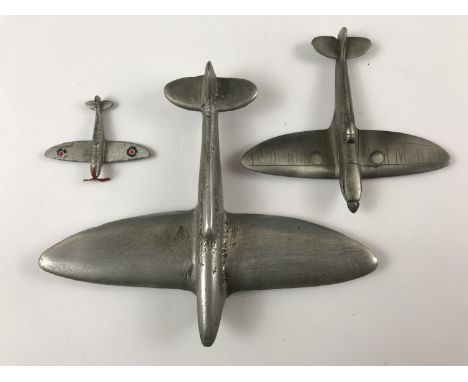 A die-cast toy and "trench art" model Spitfire aircraft 