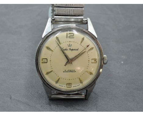 A gent's Smiths Imperial manual wrist watch having baton and Arabic numeral dial to champagne face in steel case on stretch s