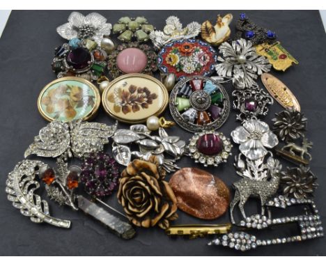 A selection of costume jewellery brooches including mosaic, Celtic style, Miracle, marcasite etc