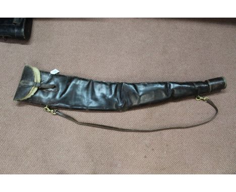 A vintage leather gun slip with brass fittings and sheepskin lining