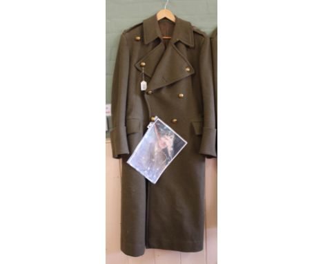 A WWII era Officers greatcoat with Norfolk Regiment buttons and Captains 'pips', inside label reads "Hector Powe" Regent St L