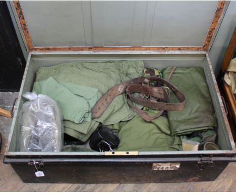A large tin trunk containing various items of British military clothing and kit