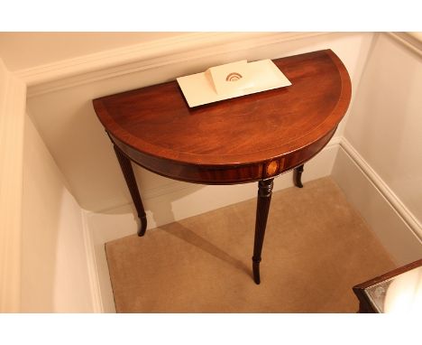 A Georgian style console table of demilune form mounted on three bowed legs 800mm x 400mm