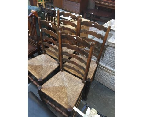 A SET OF 4 RUSH SEAT LADDER BACK CHAIRS