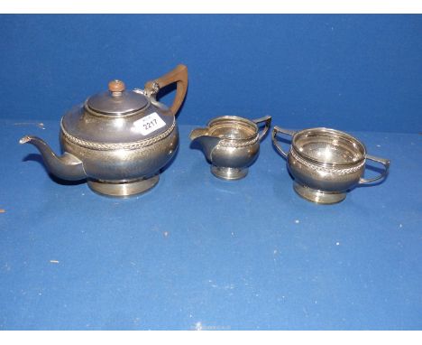 A 1920's beaten Silver three piece Teaset with rope twist band, Birmingham 1922, maker Albert Edward Jones (retailer Robinson