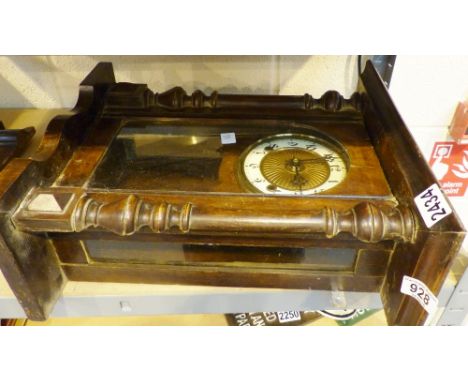 A wooden carved wall hanging chiming clock with ceramic face and Arabic chapter ring
