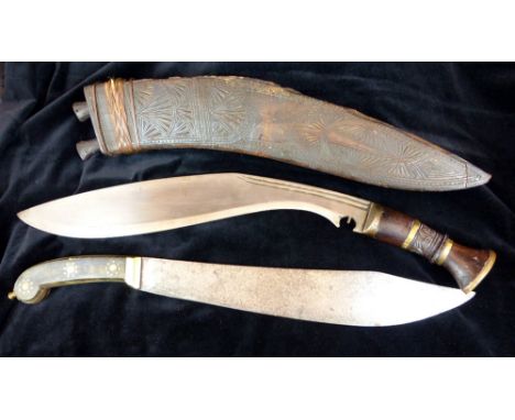 Vintage tribal kukri knives and a brass handled machete