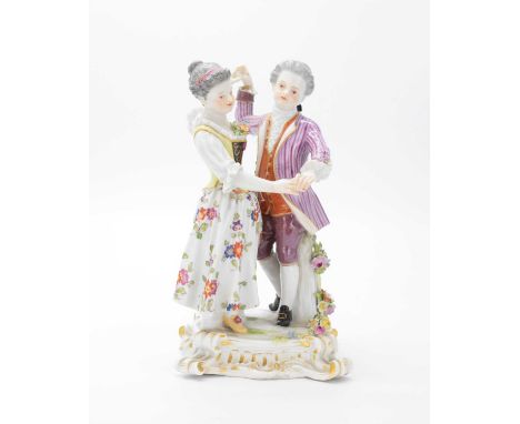 Late 19th Century Meissen figural group of a couple dancing, on square tree-stump base applied with flowers on scroll feet, b