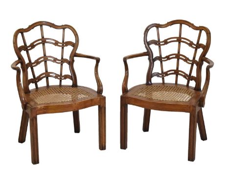 Pair of early 20th Century mahogany open arm chairs, in 18th Century taste, each with serpentine shield ladder backs and outs