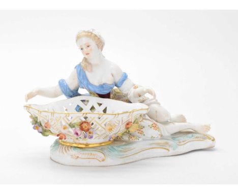 19th Century Meissen figural sweetmeat basket, modelled as a recumbent maiden supporting pierced and floral encrusted oval ba