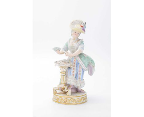 Late 19th Century Meissen figure of a lady dealing cards, after Michel Victor Acier, raised on a circular base with moulded s