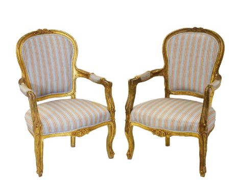 Pair of early 20th Century giltwood open armchairs or fauteuils, in the Louis XVI style, each upholstered in striped blue wat