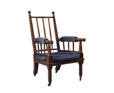 Mid 19th Century bobbin turned country house armchair, probably beech, with blue upholstered arms and cushions, raised on bra