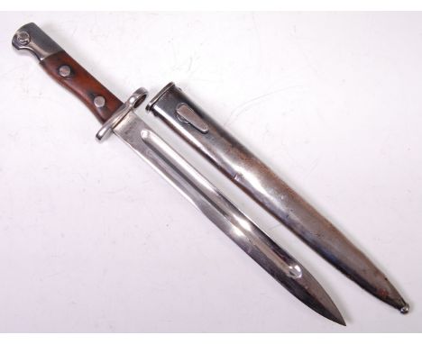 A Siamese Mauser bayonet, having a 25cm fullered blade stamped to the ricasso, with steel cross guard and two piece grip, in 