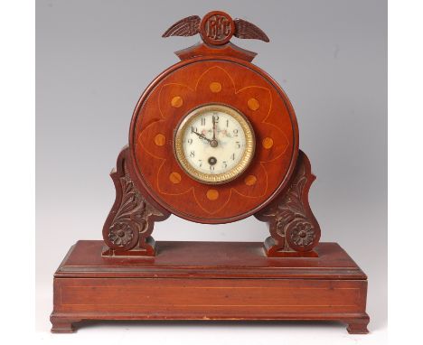 A WW I period mahogany propeller mantel clock, having a painted enamel dial with Arabic numerals within a propeller boss surr