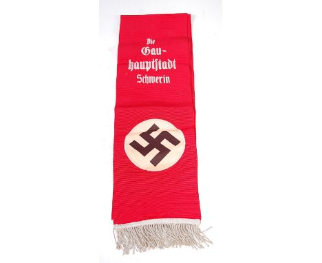 A German funeral sash having a stitched swastika emblem to each end and printed Die Gau - hauptstadt Schmerin, 188cm.