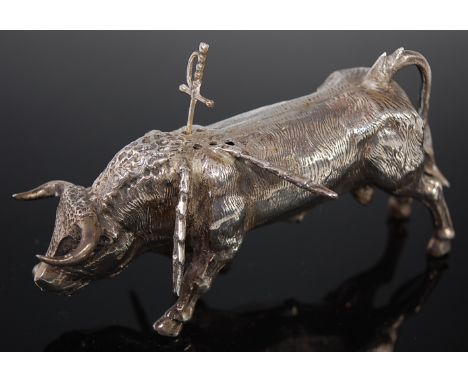 A 20th century Spanish silver model of a bull, having six apertures between the shoulder blades to hold sword shaped olive pi